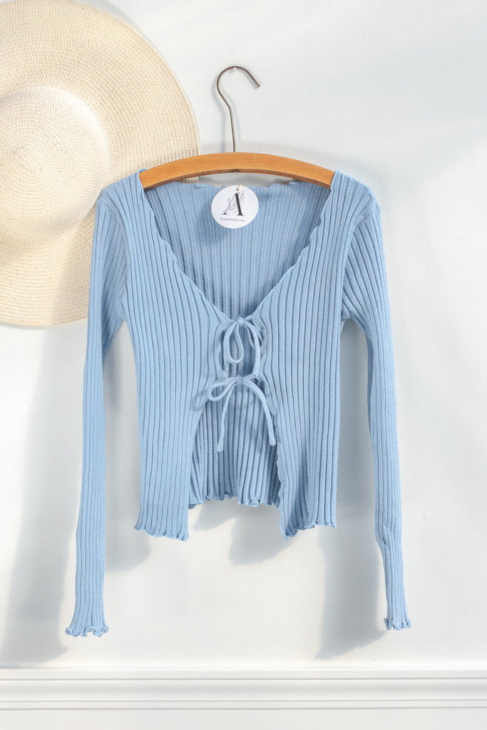 feminine tops with a french and vintage style - a light baby blue front tie top with scalloped edges - on hanger view - amantine.