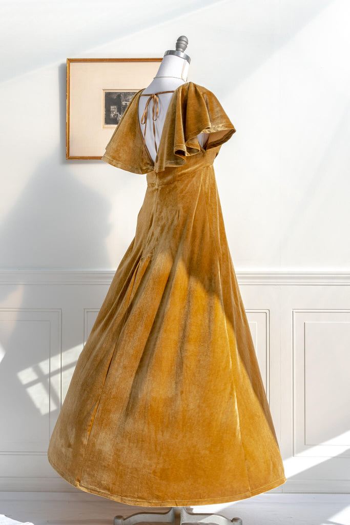 long yellow mustard velvet holiday dress - featuring a feminine cottage core silhouette, v neckline, short sleeves, and long skirt. spinning on mannequin view - amantine.