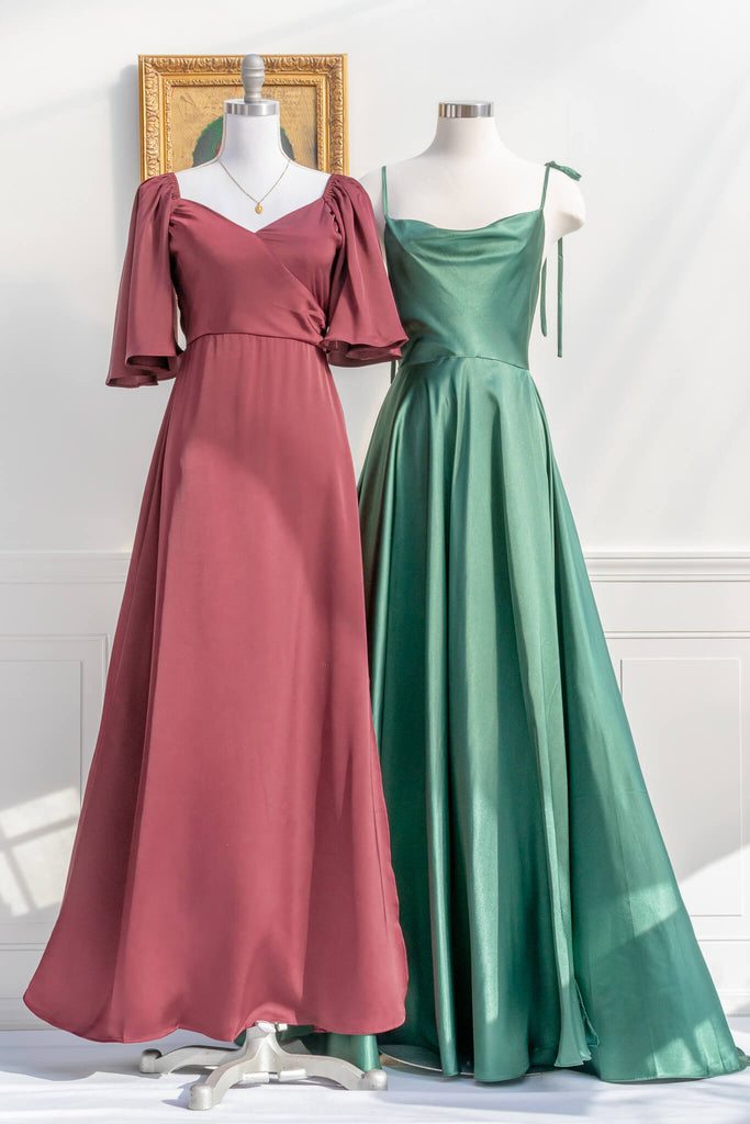 an elegant holiday dress inspired by elegant french dresses - a 3/4 sleeve burgundy silky dress with a v neckline and a long skirt. next to a feminine long green dress view - amantine.