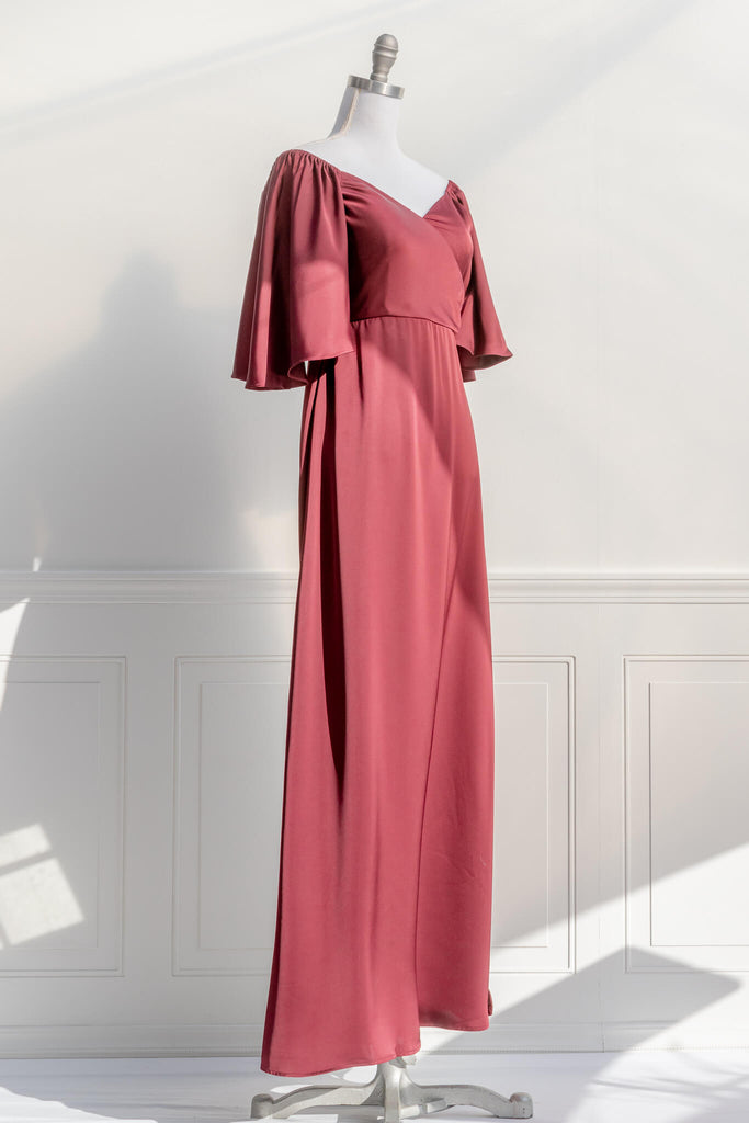 an elegant holiday dress inspired by elegant french dresses - a 3/4 sleeve burgundy silky dress with a v neckline and a long skirt. quarter view - amantine.