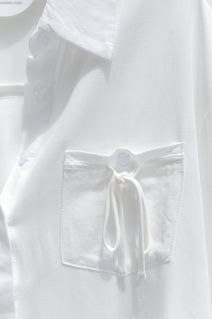 cute french style white button down shirt. front view.