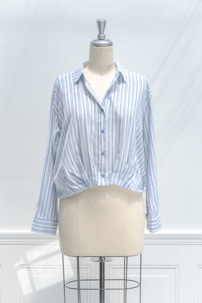 french girl style tops for work - a striped blue and white button down blouse. front view. amantine. 