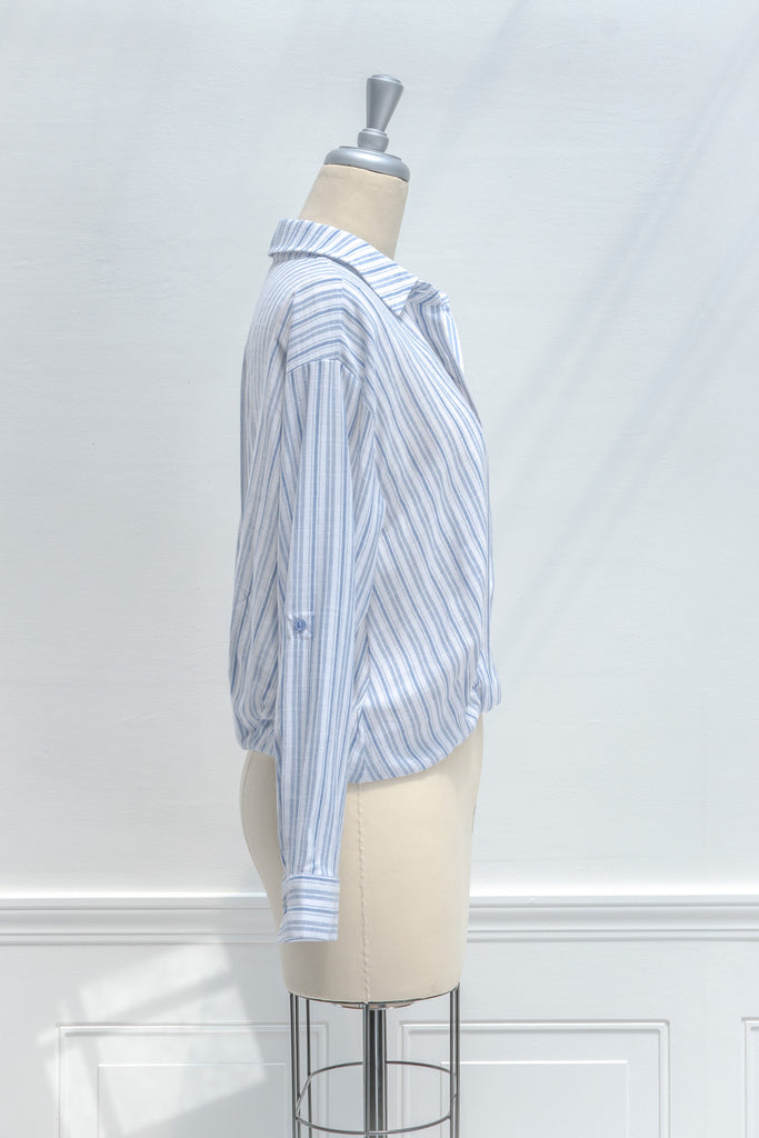 french girl style tops for work - a striped blue and white button down blouse. side view. amantine. 