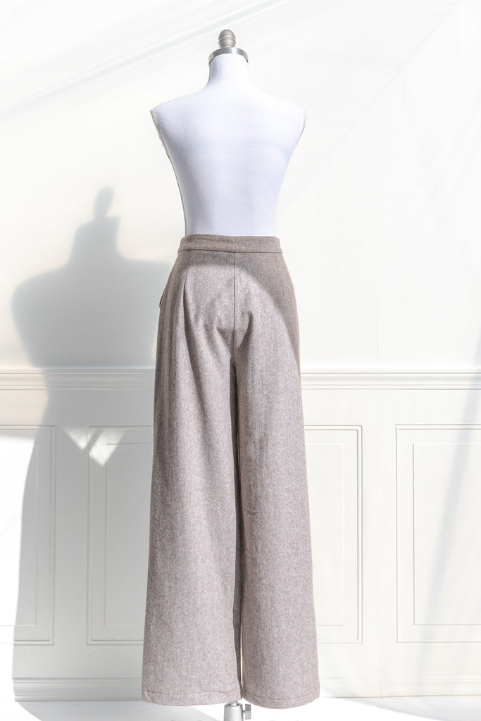 french girl style trousers. wide leg taupe pants with pockets. back view. 