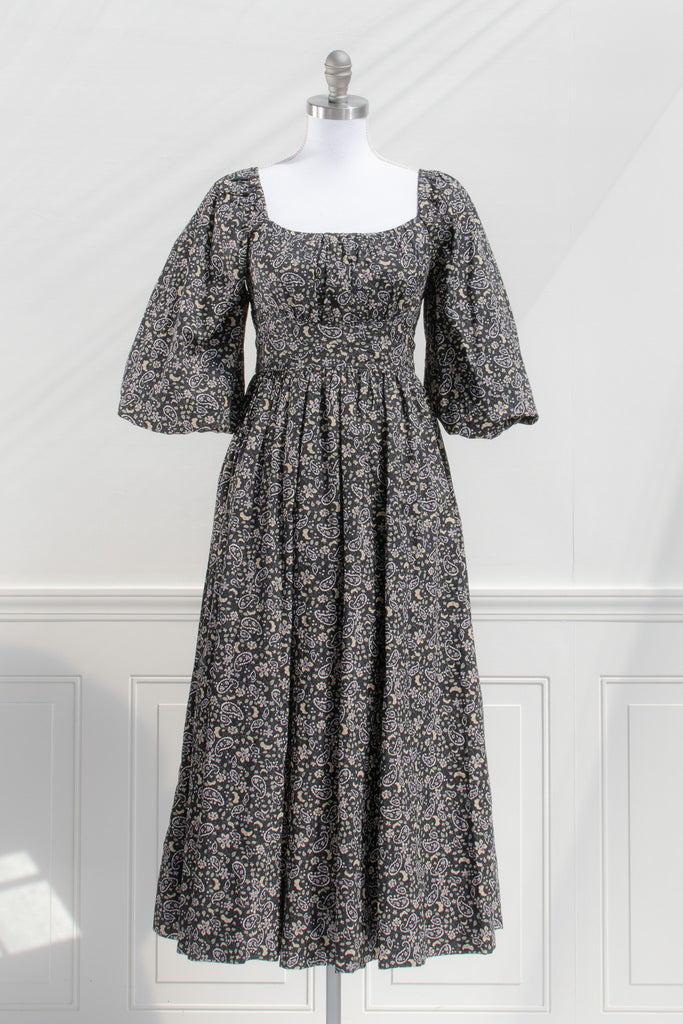 french style feminine dress - a puff sleeve square neckline full skirt floral dress. dark floral pattern. front view. 