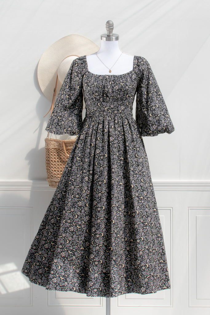 french style feminine dress - a puff sleeve square neckline full skirt floral dress. dark floral pattern. front view. 