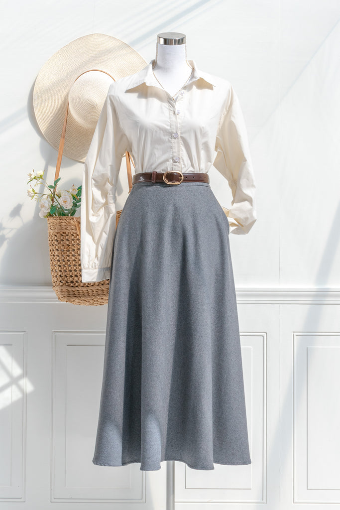 A feminine office outfit in french girl style. Cream button down long sleeve shirt with an elegant grey circle skirt. 