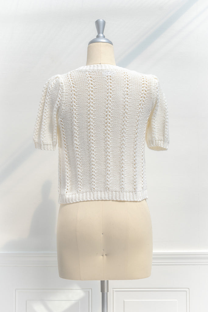 a classic light weight short sleeve sweater, crew neck. 3d bows, french girl style. back view. amantine french fashion style. 