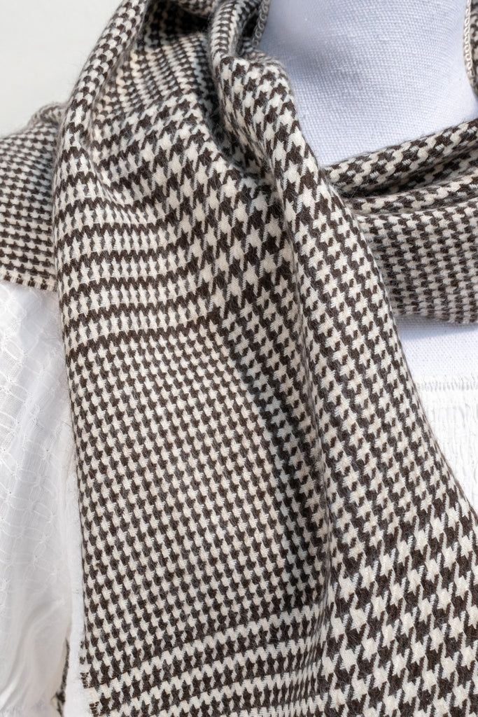 french style wide scarf in black and white houndstooth pattern. up close view of pattern on fabric. 