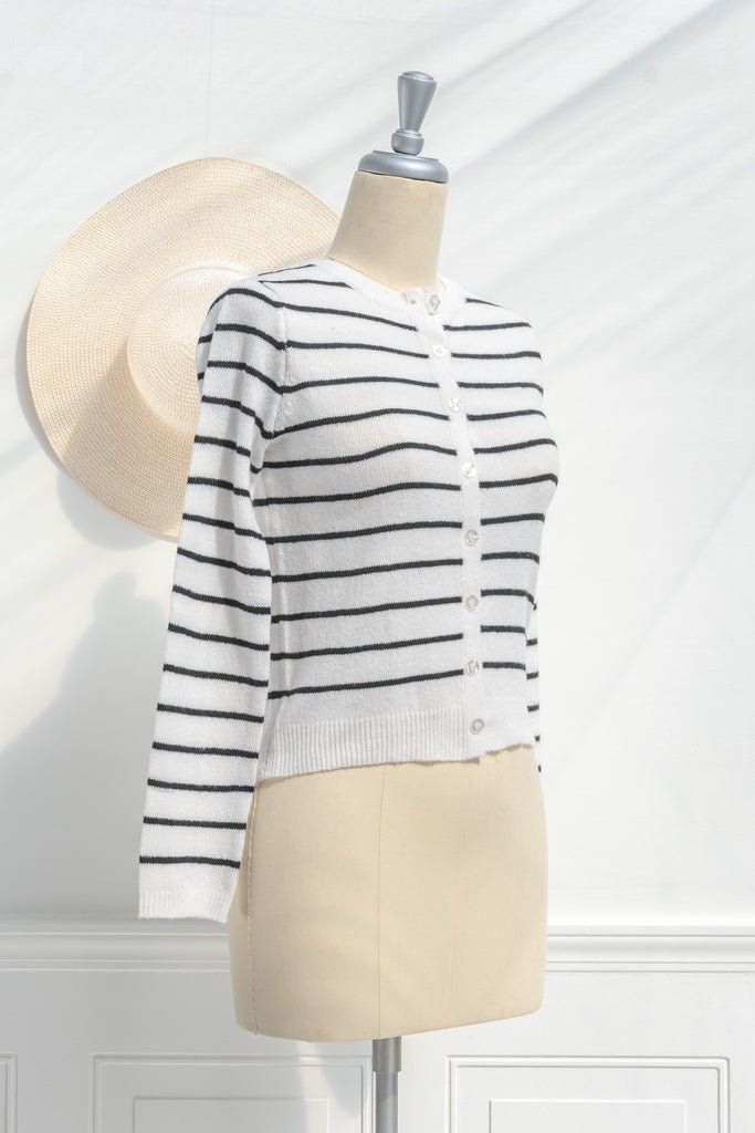 breton striped shirt - a classic light weight cardigan with black stripes against black stripes. button down long sleeve, crew neck. french girl style. side view. amantine french fashion style. 