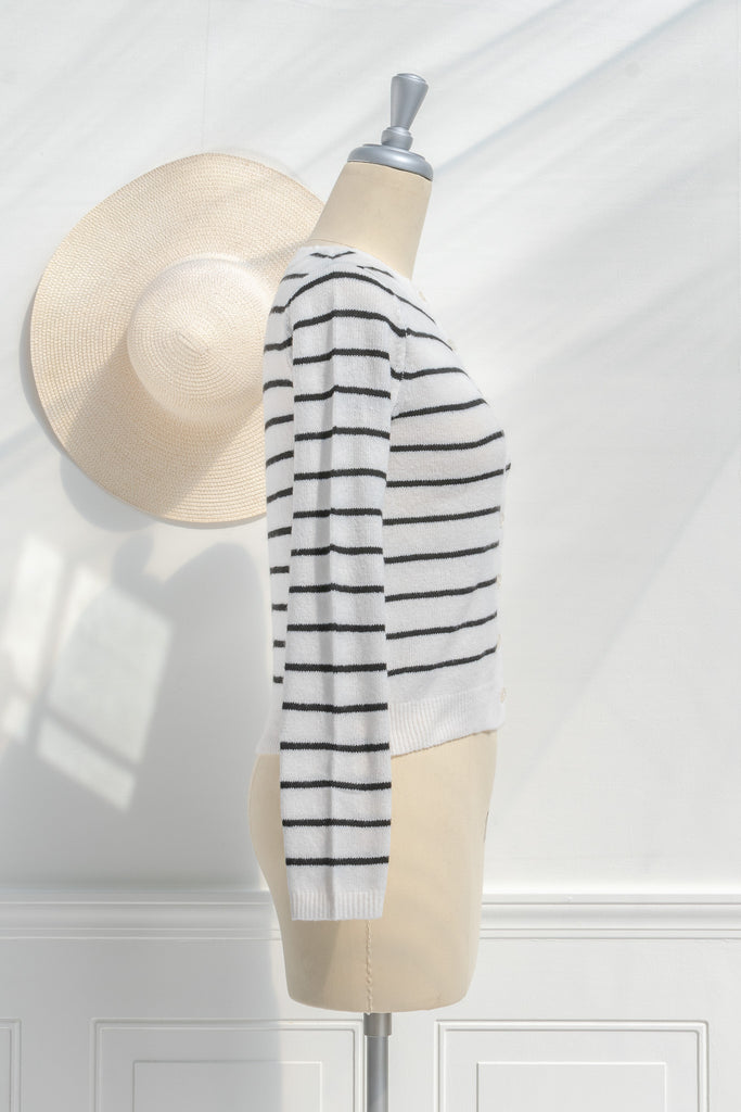 breton striped shirt - a classic light weight cardigan with black stripes against black stripes. button down long sleeve, crew neck. french girl style. side view. amantine french fashion style. 