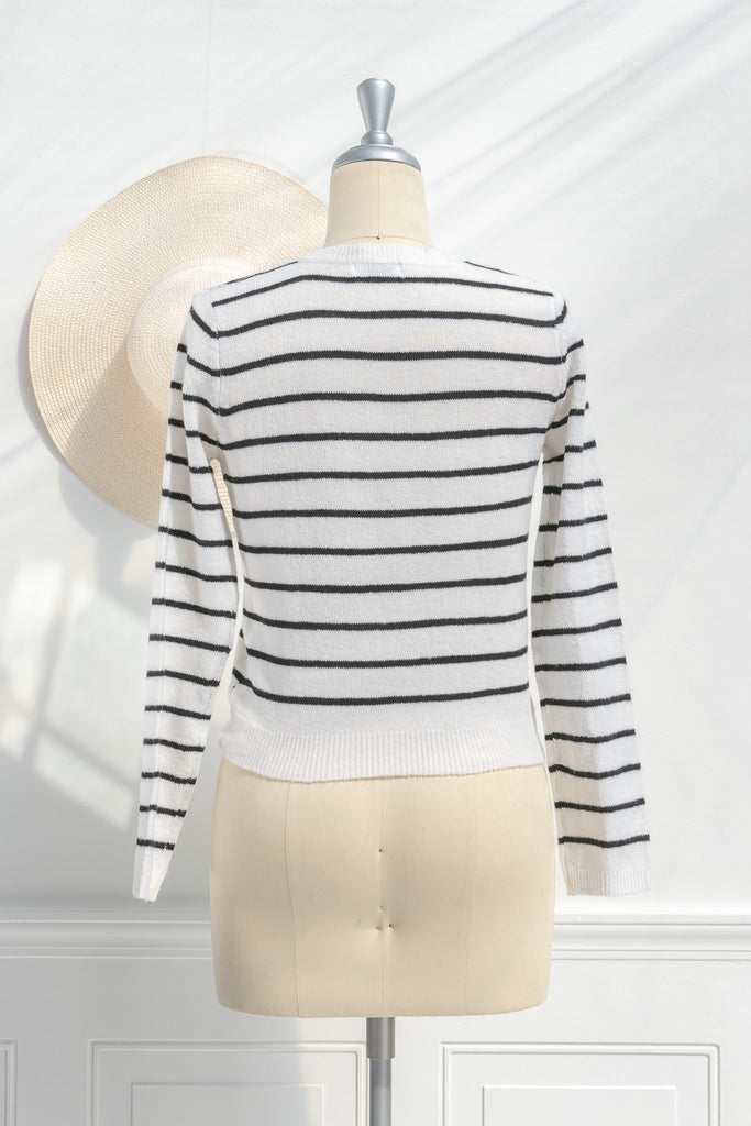 breton striped shirt - a classic light weight cardigan with black stripes against black stripes. button down long sleeve, crew neck. french girl style. back view. amantine french fashion style. 