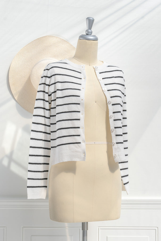 breton striped shirt - a classic light weight cardigan with black stripes against black stripes. button down long sleeve, crew neck. french girl style. 3/4 side view. amantine. 