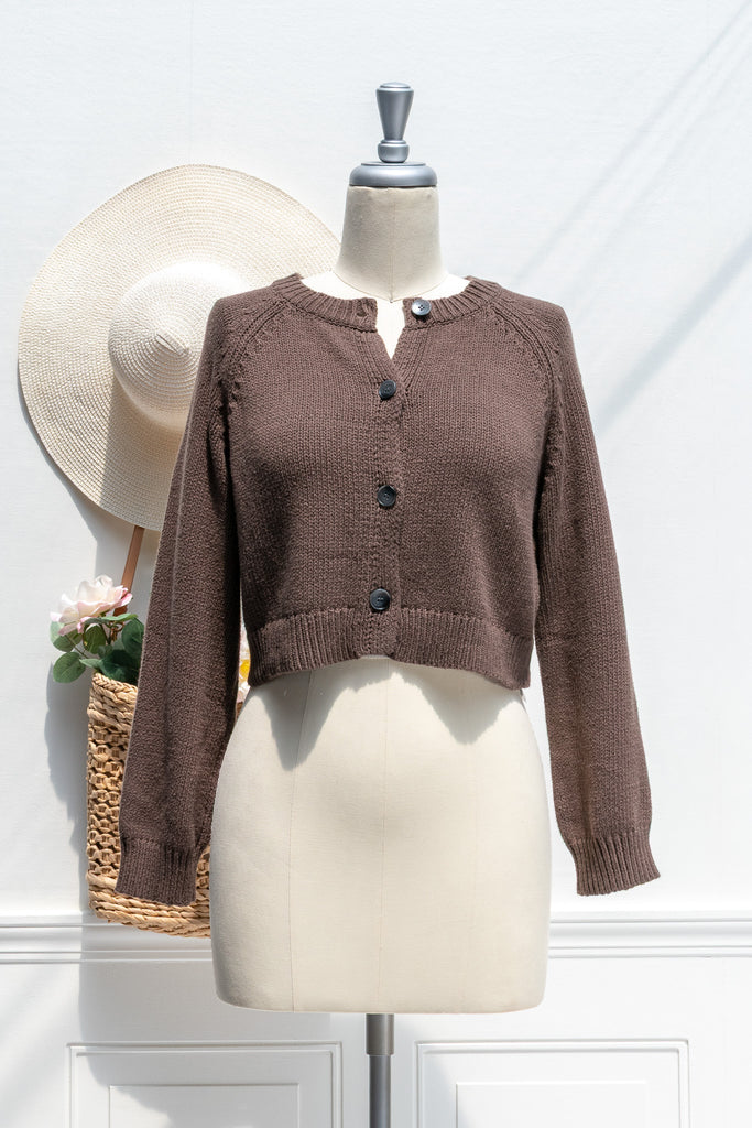 Brown knitted cardigan on a mannequin with a white background. French girl aesthetic. 