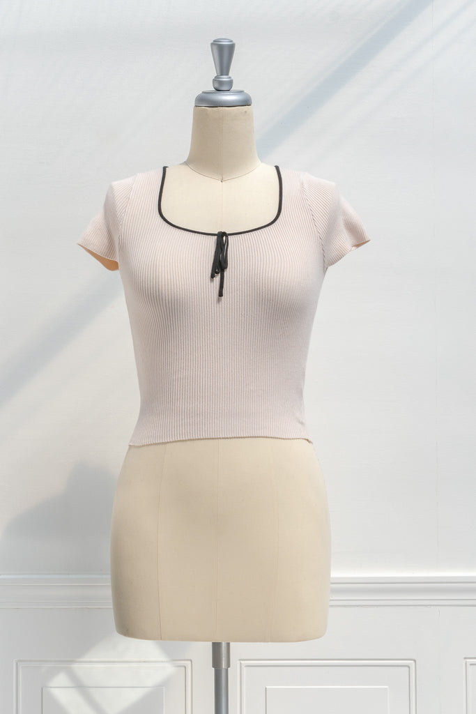 french tops - a cute knit blouse with square neckline, bow detail, and short sleeves. cropped top. front view. amantine. 