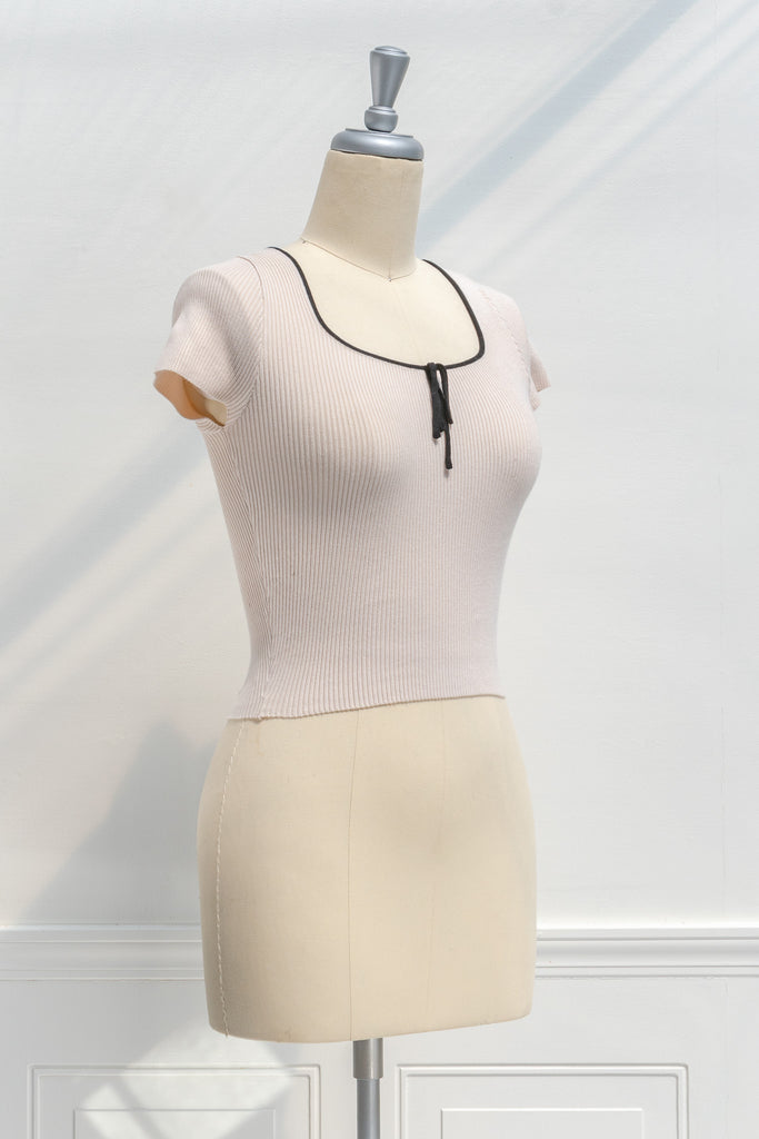 french tops - a cute knit blouse with square neckline, bow detail, and short sleeves. cropped top. 3/4 side view. amantine. 