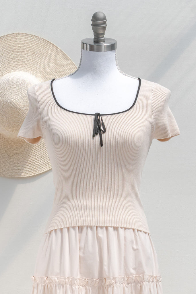 cottagecore outfit -french tops - a cute knit blouse with square neckline, bow detail, and short sleeves. cropped top. front view. amantine. 