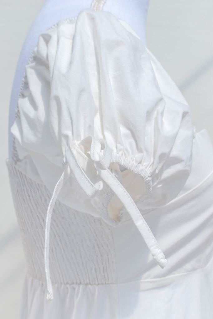 puff sleeve showing small bow detail.
