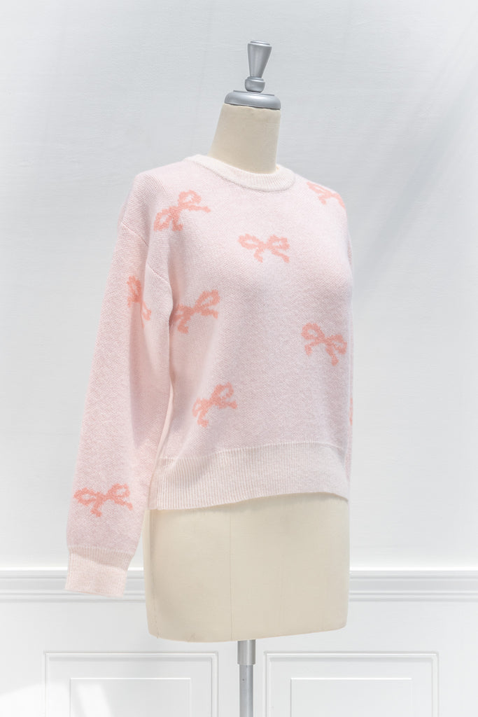 cute pink sweater - crew neck, with bow detail print. cute pink outfits. side view. 