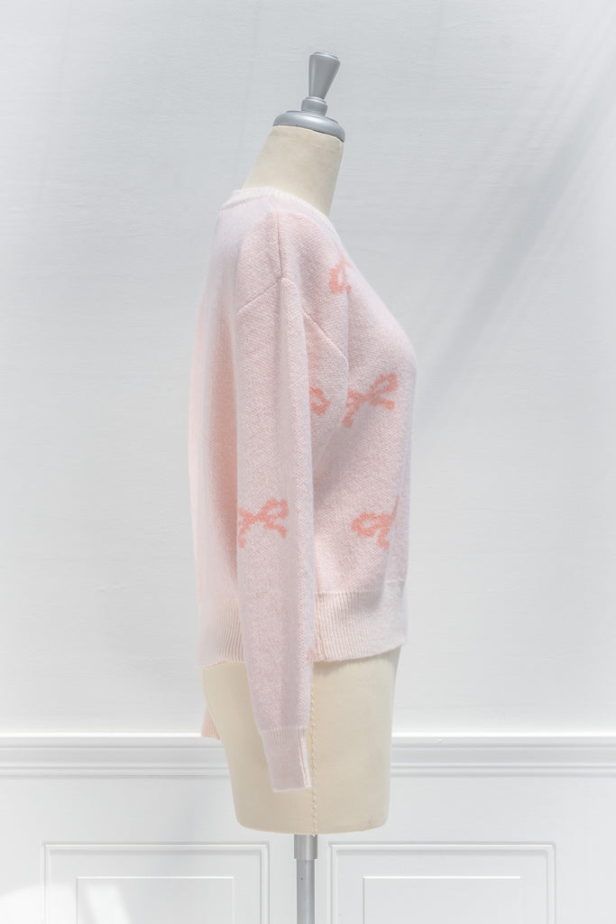 cute pink sweater - crew neck, with bow detail print. cute pink outfits. side view. 