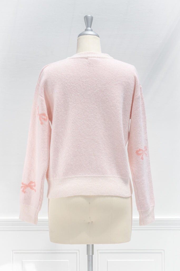 pink clothes -cute pink sweater - crew neck, with bow detail print. cute pink outfits. front view. 