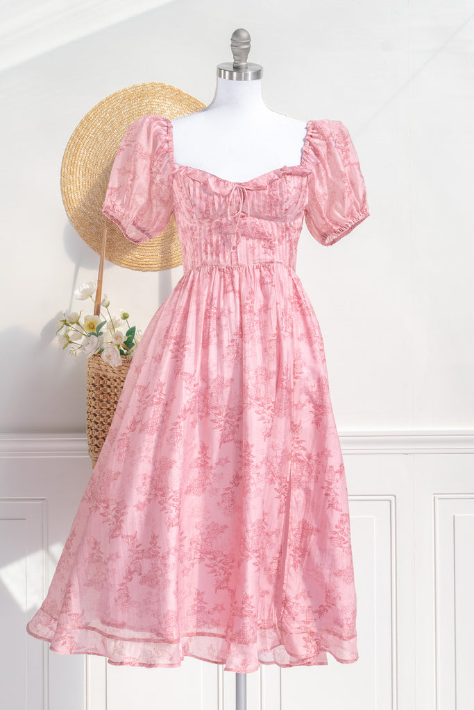 Pink Clothes -a beautiful floral pink dress with puff short sleeves, sweetheart neckline, ruched midriff, and a midi length. Perfect for spring time. Front View. Amantine pink dresses.  