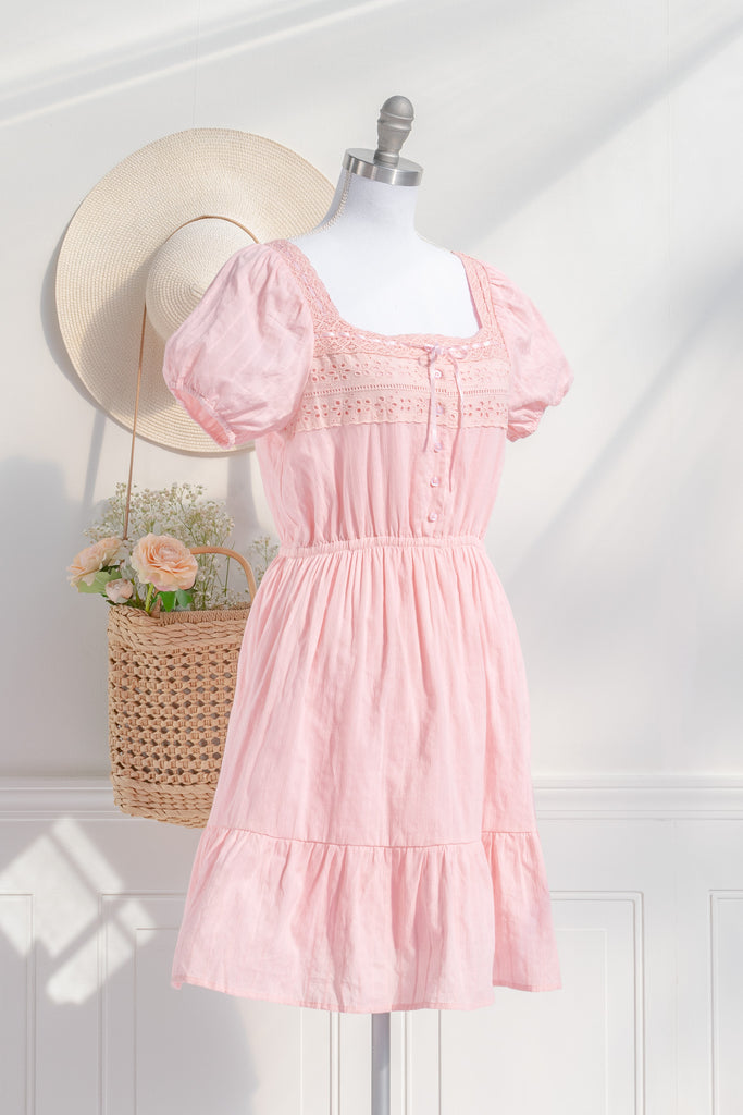 Boho pink dress with lace detail, puff sleeves, and a tiered skirt, styled for a casual chic summer look. amantine dresses. 