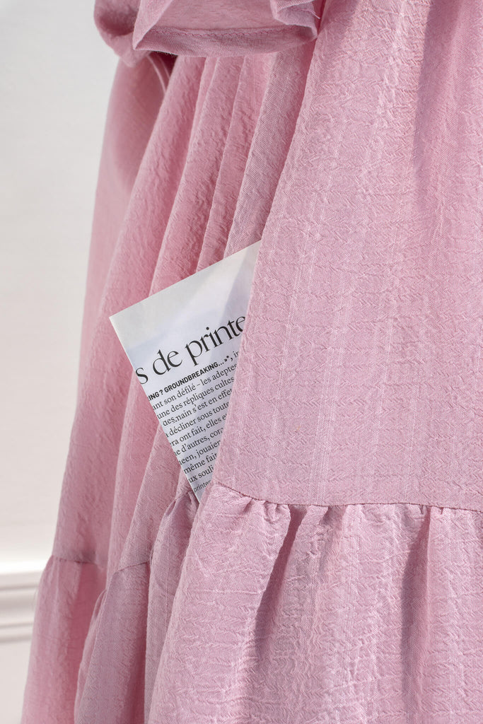pink dresses - a beautiful cottagecore style pink midi dress with puff sleeves and back bow tie. feminine pink dresses amantine. photo showing pocket detail view. 