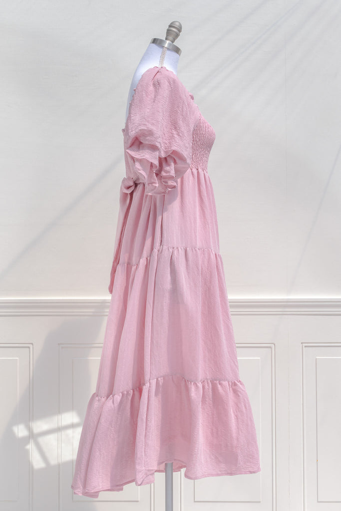 pink dresses - a beautiful cottagecore style pink midi dress with puff sleeves and back bow tie. feminine pink dresses amantine. side view. 