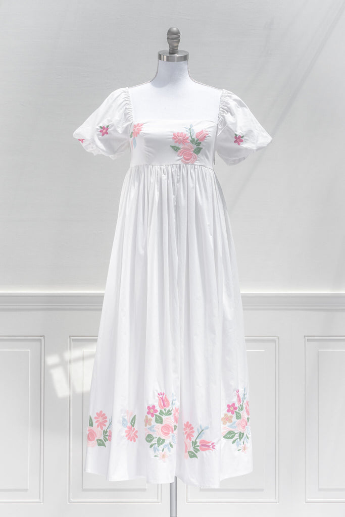 pink floral dresses - a french and cottagecore style embroidered floral cotton dress, with a square neckline, puff sleeves, and a line silhouette. front view. amantine. 