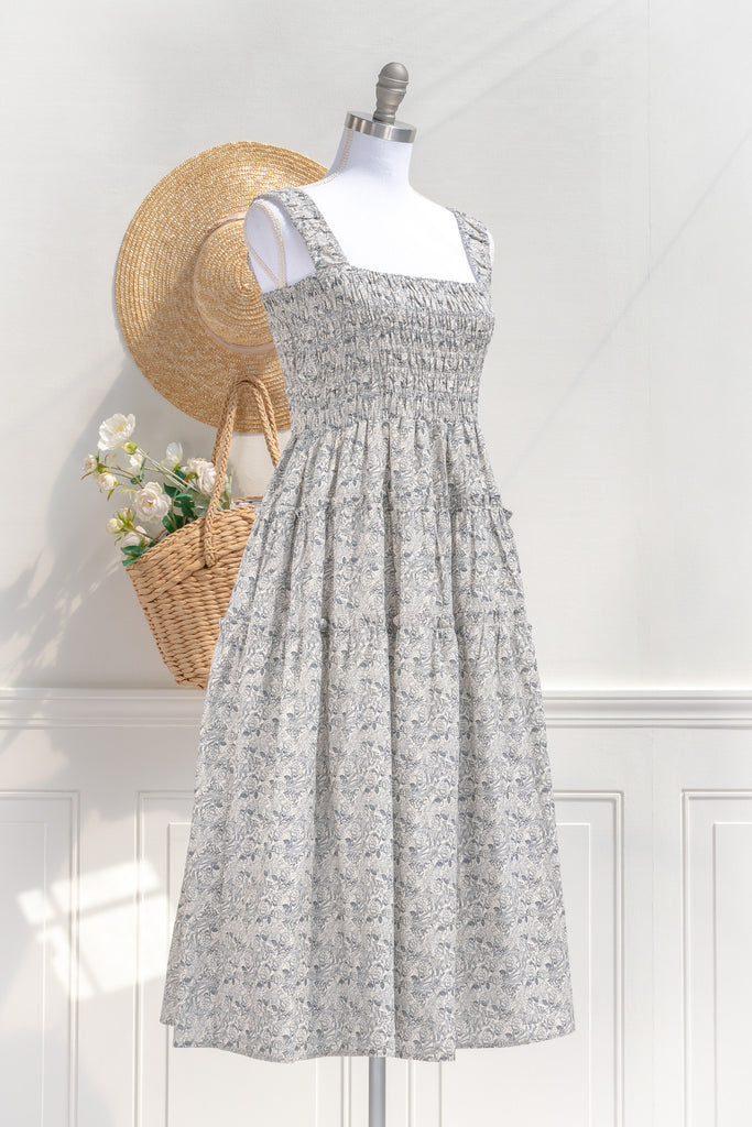 pretty dresses for spring. a romantic, vintage-inspired piece featuring a delicate floral print on a soft, blue and white floral 100% cotton. side view. amantine. 