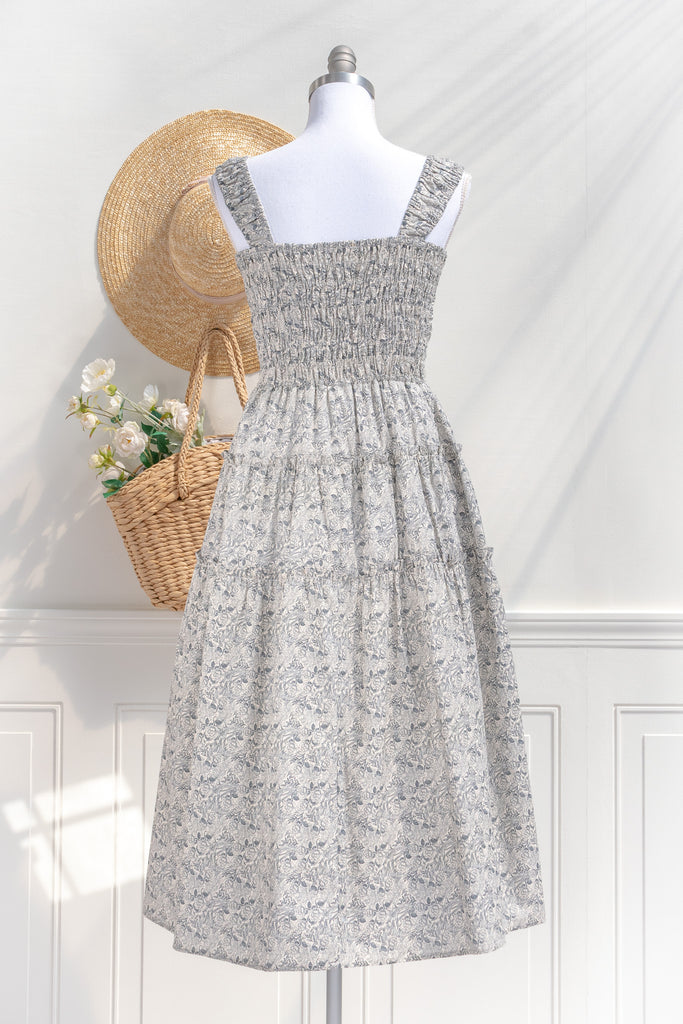 pretty dresses for spring. a romantic, vintage-inspired piece featuring a delicate floral print on a soft, blue and white floral 100% cotton. back view. amantine. 