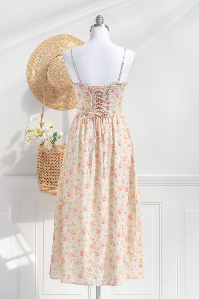 Romantic dresses - a beautiful floral cottagecore dress with structured bodice, pretty florals, on a cream fabric. perfect for the park, or to stroll. cottagecore romantic dress. back view. 