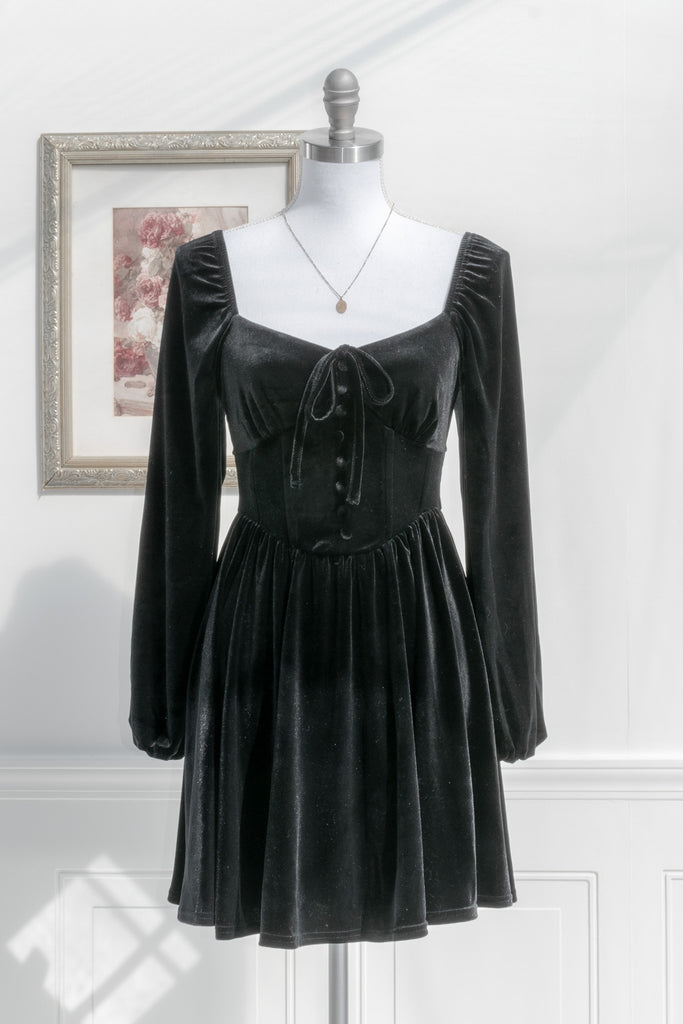 black velvet mini dress. corset style long sleeve, sweet heart neckline. Perfect for fall and the holidays. feminine dresses. front view. 