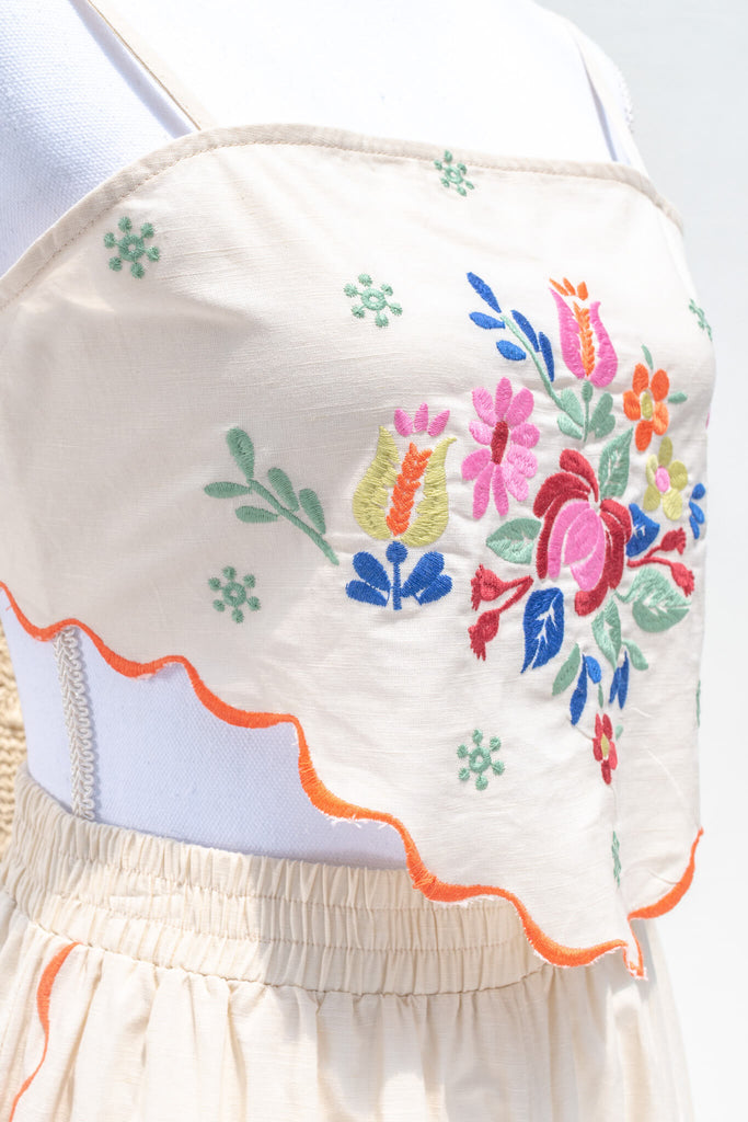 handkerchief top with floral embroidery motif. 
