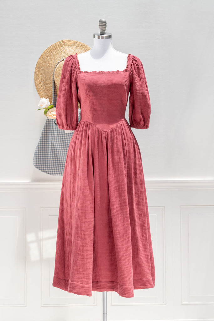 Pink dress on a mannequin with a white background