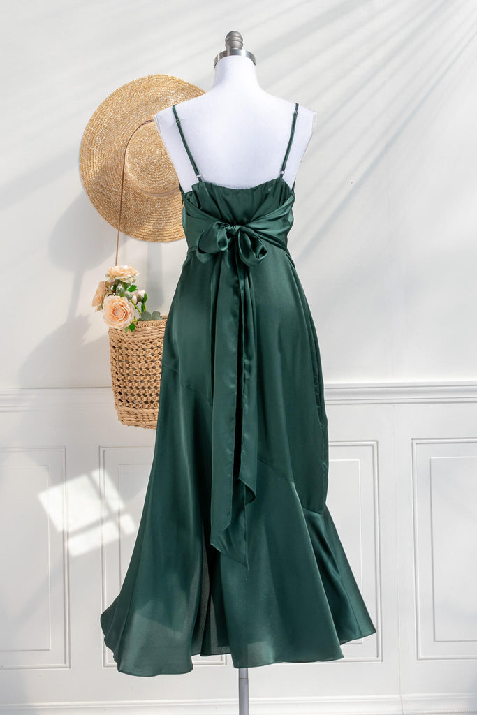 Beautiful wedding guest and formal dress in emerald green. French style feminine and romantic dress with straps, slit, and a bow. back view. Amantine dresses. 