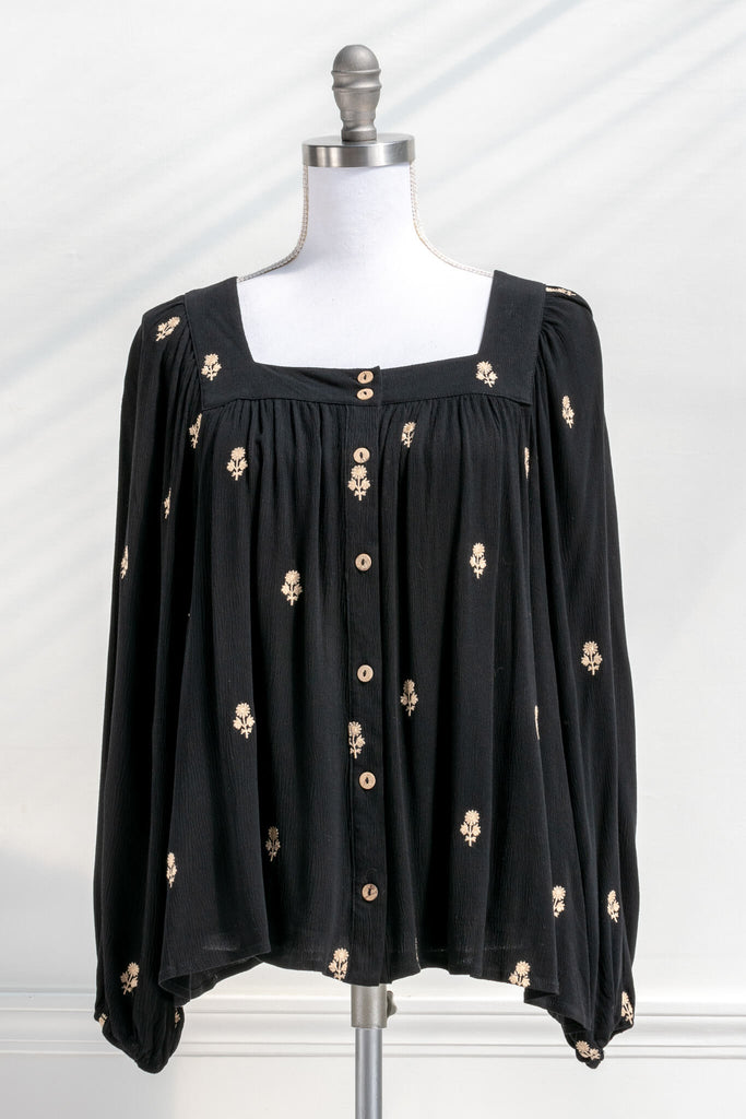Vintage fashion style from Amantine - a black button down blouse with gold thread floral details, square neckline and long sleeves 