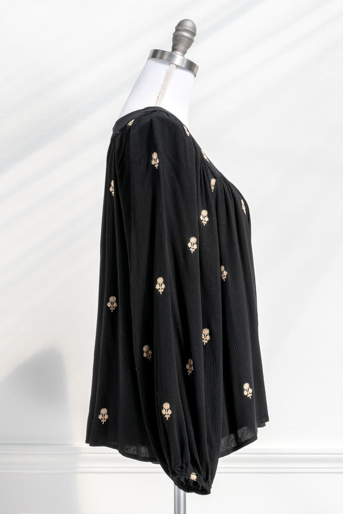 Vintage fashion style from Amantine - a black button down blouse with gold thread floral details, square neckline and long sleeves  - side view
