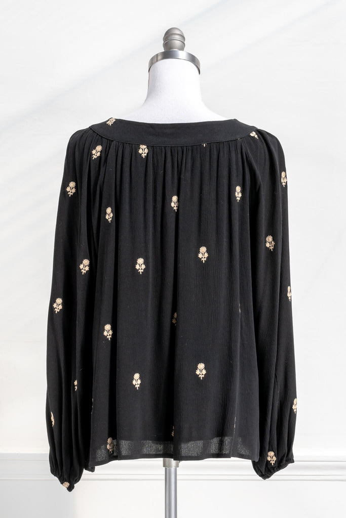 Vintage fashion style from Amantine - a black button down blouse with gold thread floral details, square neckline and long sleeves - back view