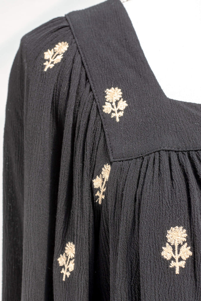 Vintage fashion style from Amantine - a black button down blouse with gold thread floral details, square neckline and long sleeves - fabric up close detail