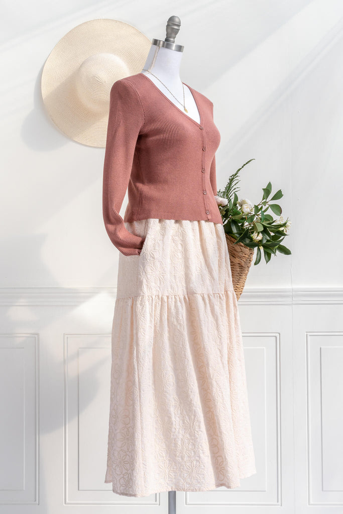 feminine dresses and sweaters - a coral colored cardigan button down styled with a feminine skirt from Amantine 