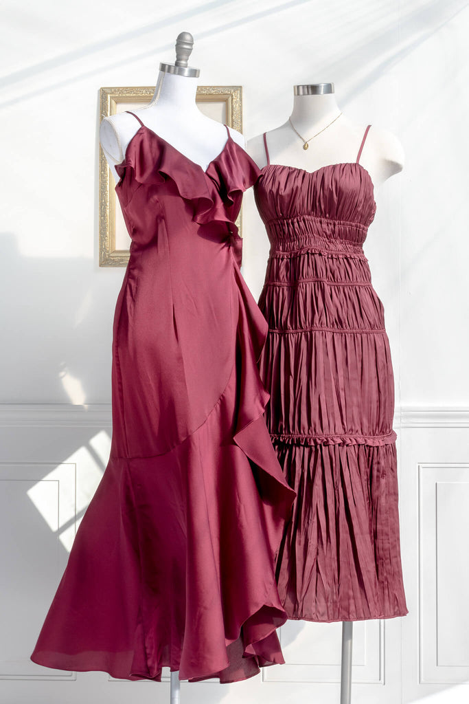 feminine dresses and clothing, a burgundy dress, romantic style, with ruched textured satin fabric and spaghetti straps, next to a wrap dress 